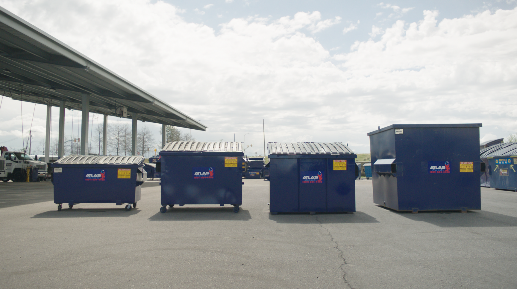 Containers Atlas Disposal front loader dumpsters lined up referring to The Do's and Don'ts of Dumpster Rentals Image from Atlas disposal
