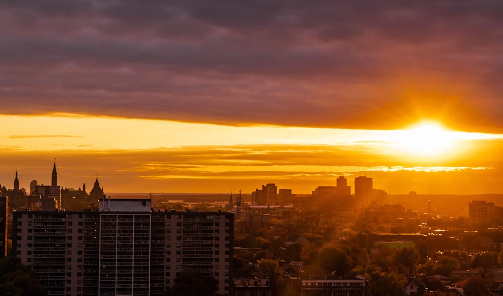 The sizzling sunrise covering a city where Atlas Disposal trucks dispose of waste and recycling materials. 