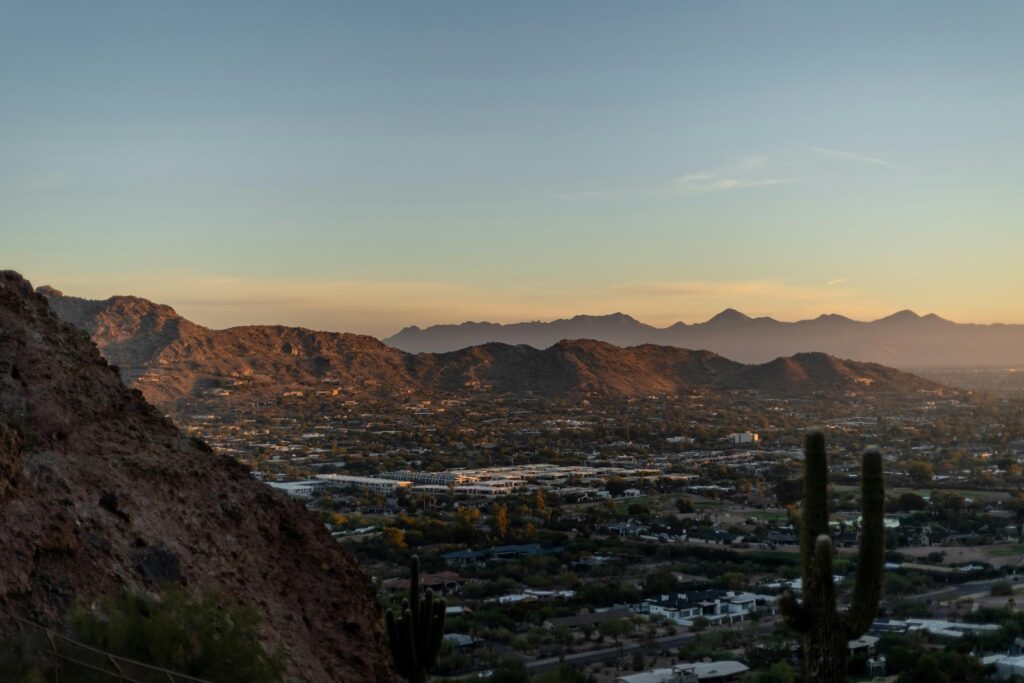  Scenic view of Phoenix Valley at sunset with desert mountains and cacti — showcasing the region served by Atlas Disposal’s roll off dumpster rentals.
