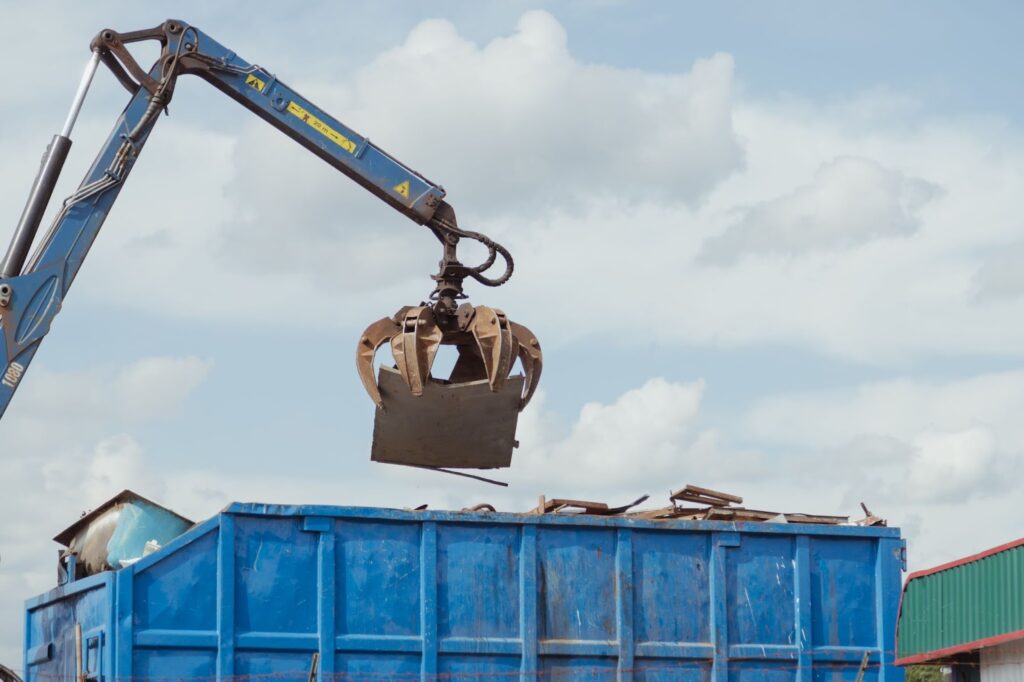 A large blue construction dumpster safely and efficiently removing debris on an industrial scale in Chandler, AZ.